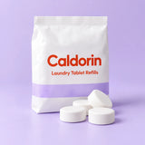 Caldorin Laundry Detergent Tablet Refills in a clean pale-blue and lilac studio setting